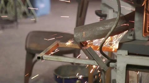 Working man cuts metal square pipes on the machine. Stock Footage 175422506