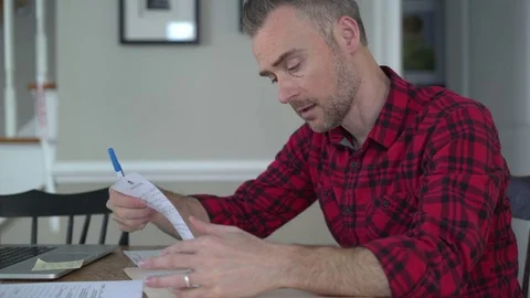 A working man does his taxes Stock Footage 72612865