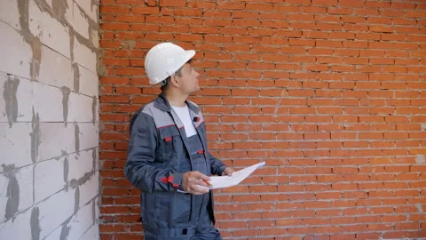 Working man with draft on site Stock Footage 98087304