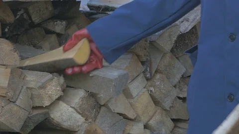 Working man hands in gloves puts the wood near the barn walls of the house Video stock 69753084