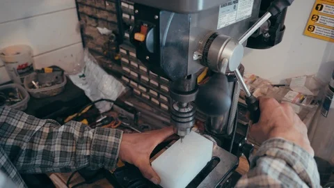 Working man operates drill press in workshop Видео 104075728