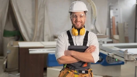 Working man in overalls looks into the camera and smiles Stock Footage 126215604