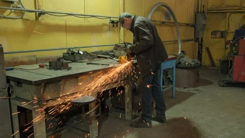 A working man uses a circular saw to cut metal. Work in a repair shop. Stock Footage 260623258