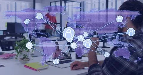 Working man wearing plaid at right desk using laptop in office with holographic 写真素材