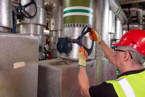 Working mechanical engineer in hard hat and high visibility vest Stock Photos