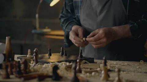 Working, Medium-sized business owner Concentrated Looking at a chess piece I Stock Footage 247402603
