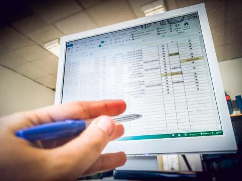 Working with microsoft excel at the office Stock Photos