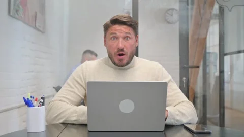 Working Middle Aged Man Shocked while Looking at Camera Видео 304726439