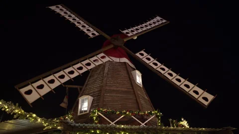 A working mill in an amusement park. An old mill decorated with a Santa hat. Video stock 262696289