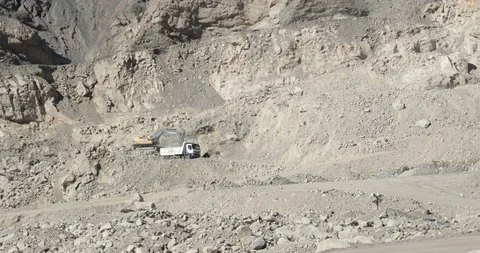Working mine. Mechanical shovel working, putting stones Stockbeeldmateriaal 97375925