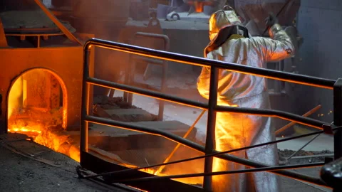 Working with molten cast iron - Industry worker in suit in factory Stock Footage 249620992