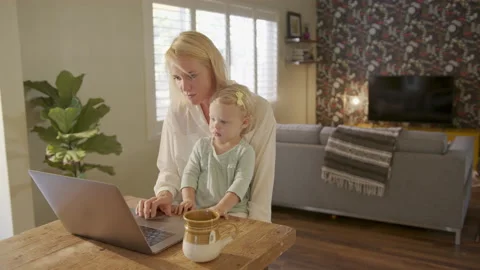 Working Mom Responding to Emails with Daughter on Her Lap Stock Footage 133287495