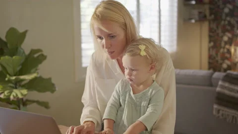 Working Mom Responding to Work Emails with Daughter on Her Lap Stock Footage 133283213