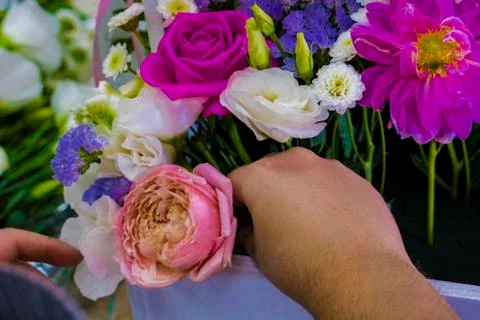 The working moment of preparation and dressing of the bouquet. Orchid, eustoma. Stock Photos