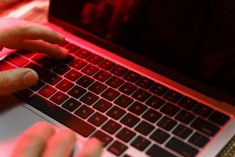 Working on a neon computer keyboard with colored backlighting. Computer vid.. 스톡 사진