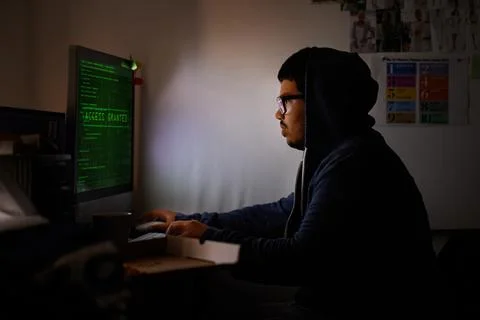 Working on a new game. a young programmer focused on his work. Stock Photos