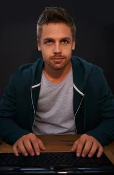 Working on a new game. a young programmer focused on his work. Stock Photos