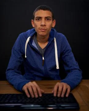 Working on a new game. a young programmer focused on his work. Stock Photos