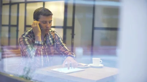 Working on new tablet. Low angle view of confident young man working on digital Stock Footage 68991189