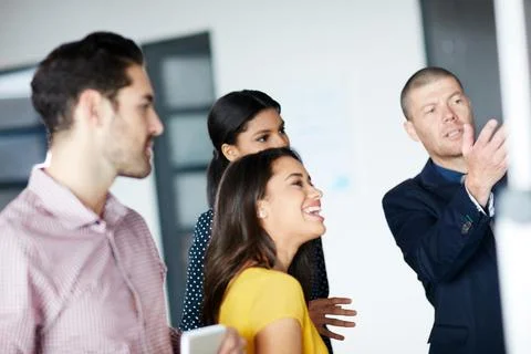 Working on the next big thing. four businesspeople working in the office. Stock Photos
