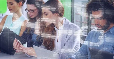 Working office colleagues analyzing data on laptop and documents in open office, Foto stock