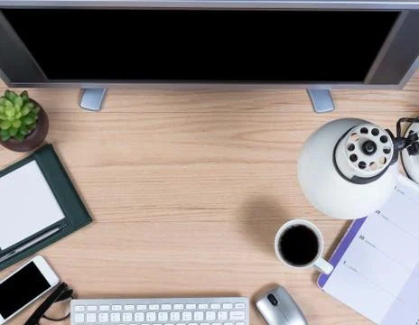 Working office desktop in overhead view on oak wood Stock Photos