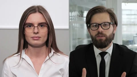 Working from office during pandemic between two people. Group video call. Video stock 143473128