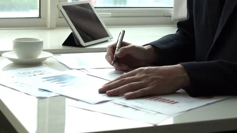 Working in office with graph Stock Footage 84474299