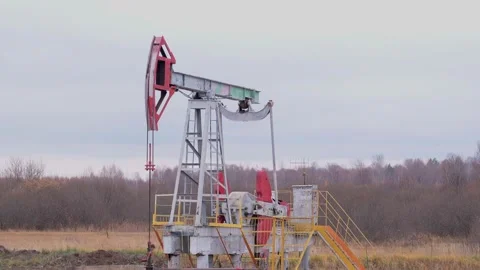 A working oil pump against the background of an autumn forest Stock Footage 163284376