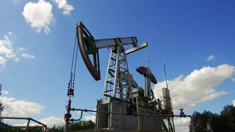 Working oil pump on a background of blue sky. Keep nature Stock Footage 114654647