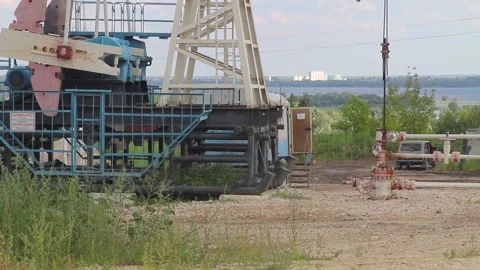 Working Oil pump on a background of blue sky with clouds on a summer day Stock Footage 137757021