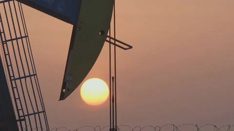 Working oil pump in deserted district at sunset Stock-Footage 146552765