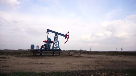 Working oil well. Cloudy sky. Stock Footage