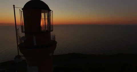 Working old lighthouse on a sunset background in the sea in summer. Stock-Footage 87846614