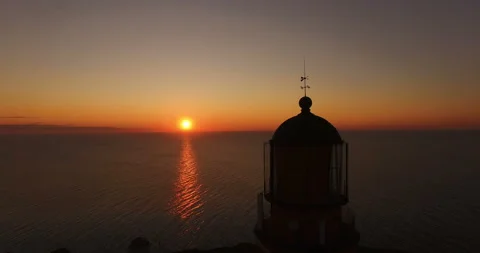 Working old lighthouse on a sunset background in the sea in summer Video stock 87868240