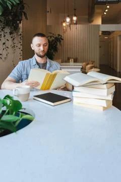 Working on online education while reading books in a modern workspace with .. Photos