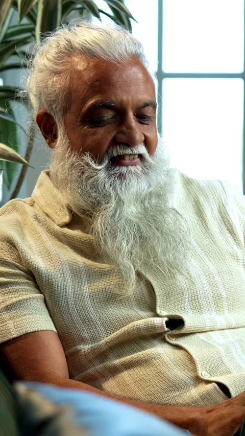Working online from sofa, Indian mid age stylish bearded man focused on laptop Stock Footage 342757118