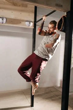 Working out armless man training in the gym, doing pull ups with one hand Stock Photos