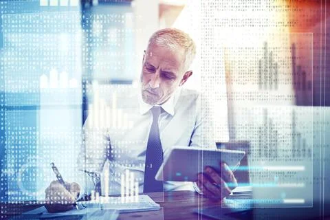 Working out the bugs in his code. a mature businessman working on programming 库存照片