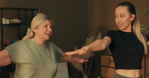 Working out process. Women having fun together warming up doing stretching at 库存影片 218855871