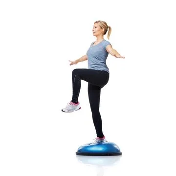 Working out using the proper techniques. An attractive young woman working her Stock Photos