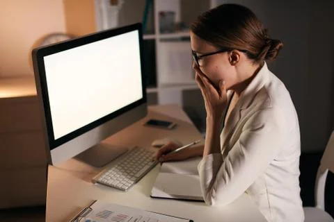 Working overtime in the office space alone at the table. Stock Photos