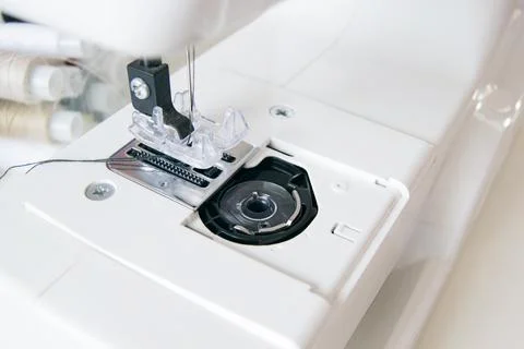 Working part of an antique sewing machine. Selective focus on plastic shuttle Stock Photos