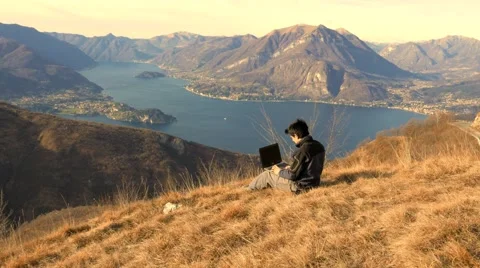 Working on the PC at sunset in the mountains Stock Footage 59717106