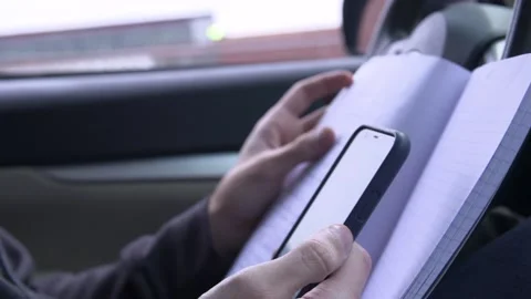 Working with phone and notepad in car 스톡 동영상 139070309
