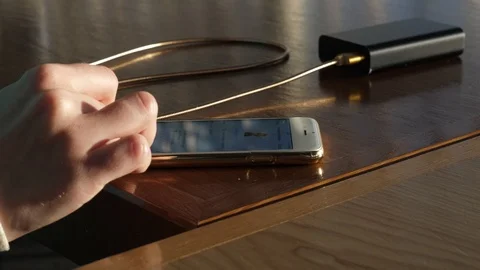 Working with the phone standing on the charge from the power bank Stock Footage 89110706