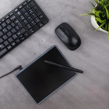 Working place on dark table with copy space. Keyboard, computer mouse, pen, g Stock Photos