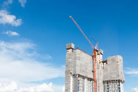 Working on place with tall buildings under construction and cranes Stock Photos