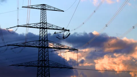 Working on a power pole against dramatic sky Stock Footage 163084916