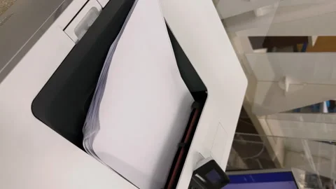 Working printer.View from above of MFP printer printing something on white paper Stock Footage 248867620